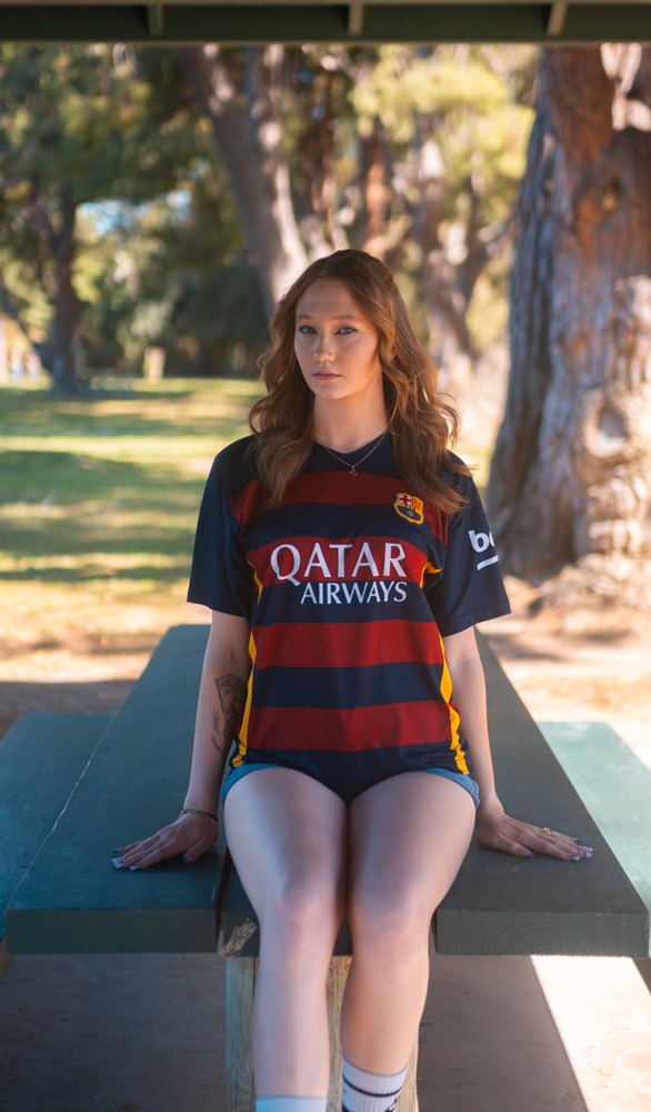 Seated on a picnic table, hands at sides