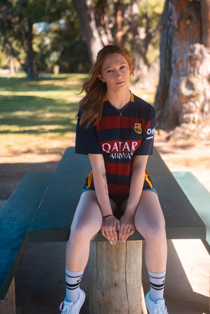 Seated on a picnic table, direct gaze