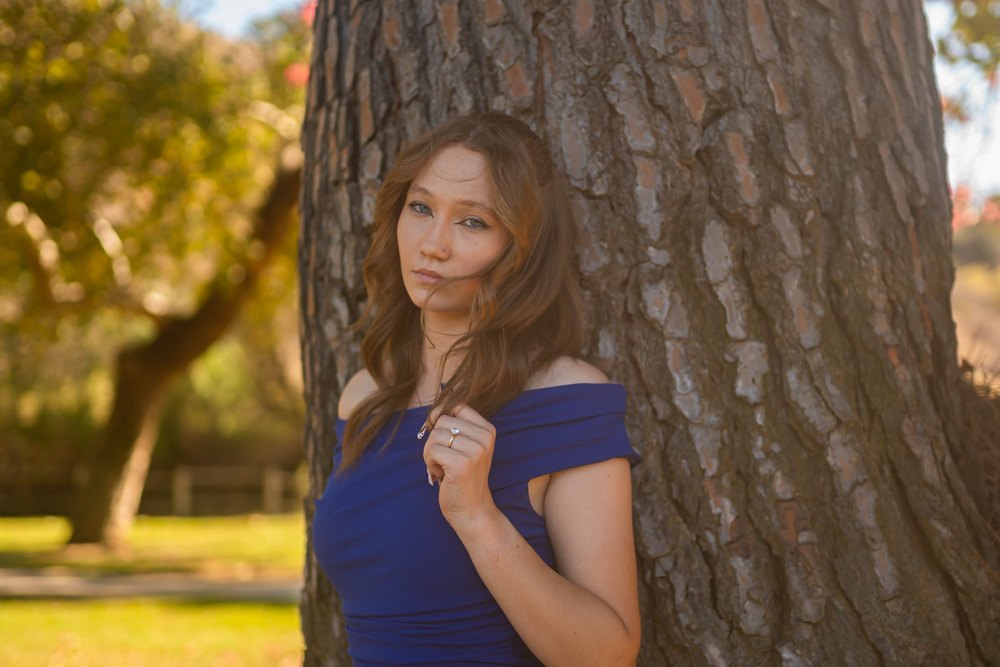 Close portrait beside a pine trunk