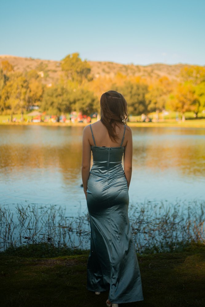 Back view in satin gown facing the lake